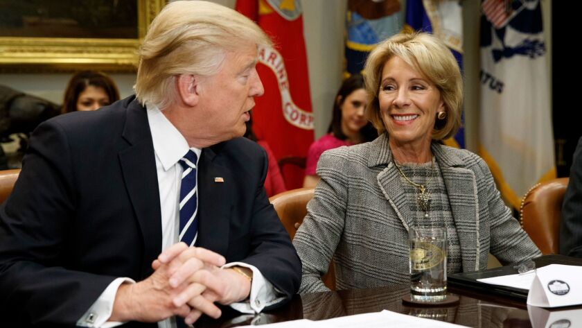 Donald Trump talks to Education Secretary Betsy DeVos in the Roosevelt Room of the White House in Washington on Feb. 14.