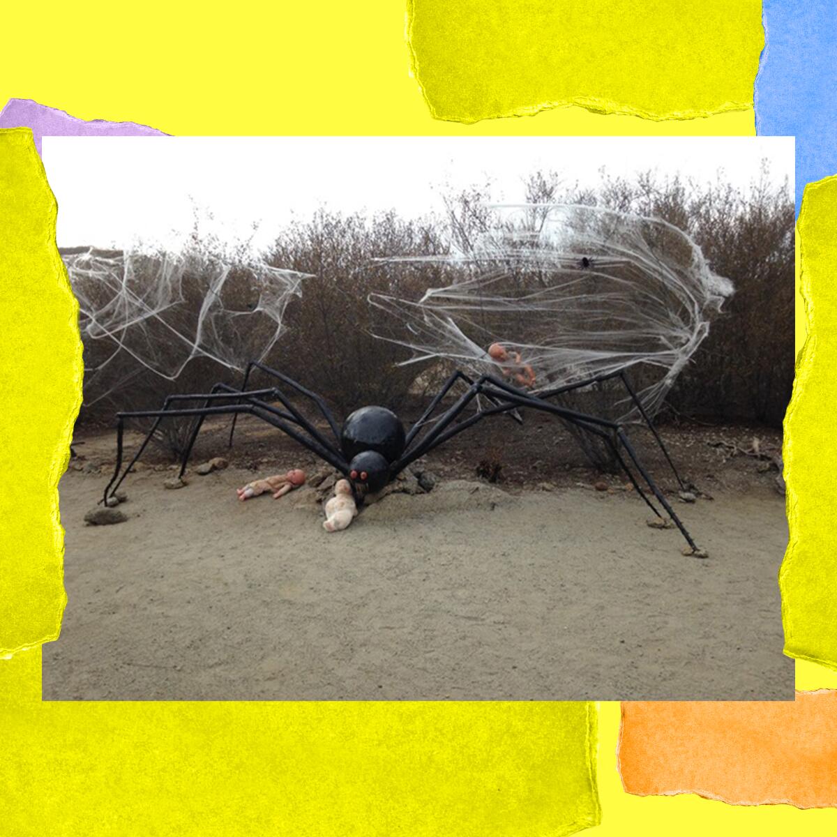 A large metal spider sculpture is decorated with cobwebs.