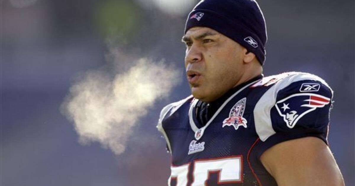 New England Patriots linebacker Junior Seau (55) hoists the AFC Championship  Lamar Hunt trophy after the team defeated the San Diego Chargers 21-12 in  the AFC Championship game at Gillette Stadium in