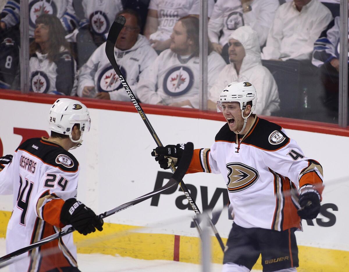 Ducks defenseman Cam Fowler (4) celebrates with teammate Simon Despres after scoring in the first period of Game 3.