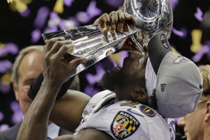 Ed Reed holds the Lombardi Trophy after the Ravens' victory in the Super Bowl.