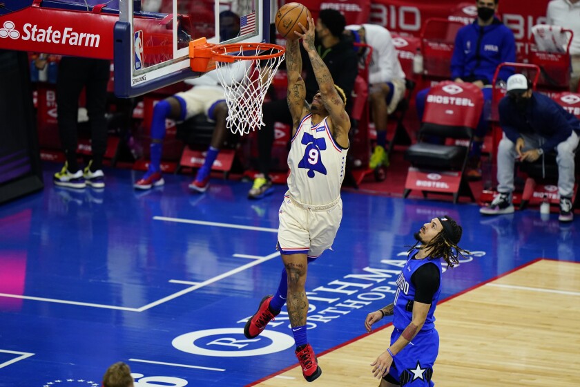 Philadelphia 76ers' Rayjon Tucker (9) goes up for a dunk against Orlando Magic's Cole Anthony (50) during the second half of an NBA basketball game, Sunday, May 16, 2021, in Philadelphia. (AP Photo/Matt Slocum)