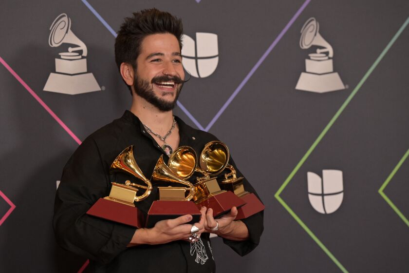 Colombian singer Camilo poses with his awards in the press room during the 22nd Annual Latin Grammy awards at the MGM Grand Arena in Las Vegas, Nevada, November 18, 2021. (Photo by Bridget BENNETT / AFP) (Photo by BRIDGET BENNETT/AFP via Getty Images)
