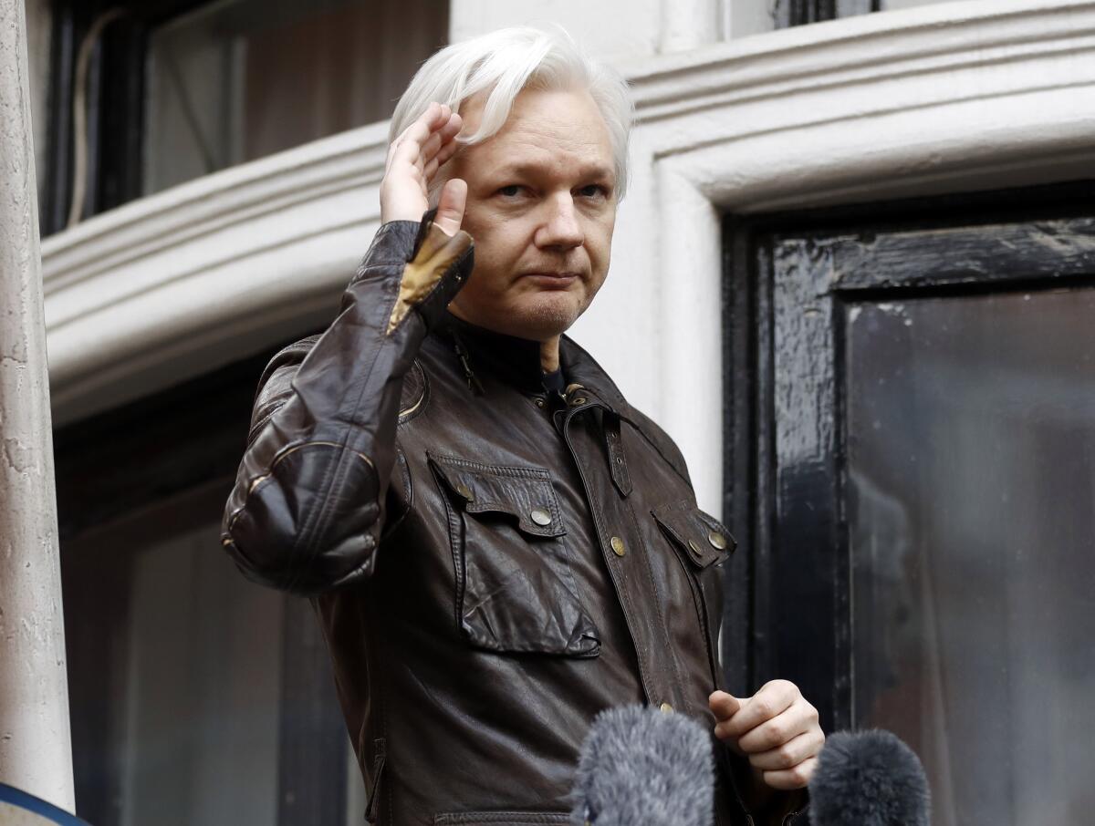 WikiLeaks founder Julian Assange greets supporters from a balcony of the Ecuadorian Embassy in London in 2017.