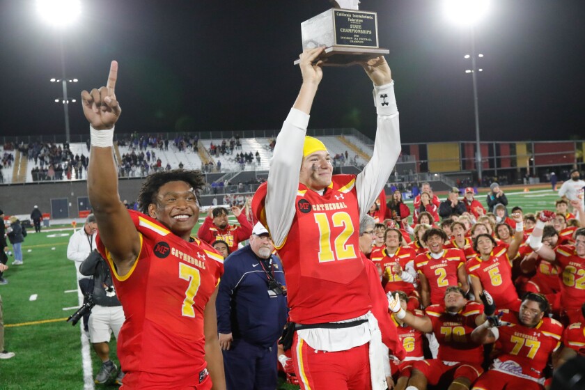 Running back Lucky Sutton (7) and quarterback Charlie Mirer of Cathedral Catholic celebrate the Dons' state title. 