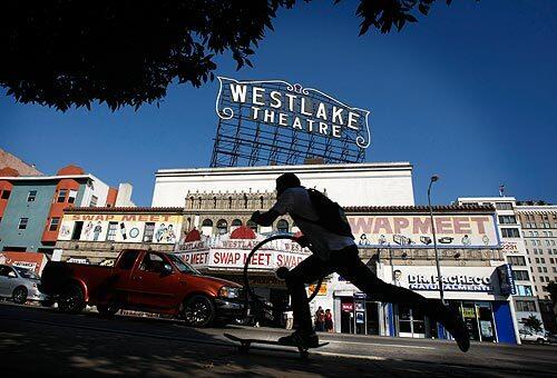 The Westlake Theatre on Alvarado Street across from MacArthur Park will be restored after being used as a swap meet since the 1990s. The move pleases preservationists, but vendors wonder where they will relocate.