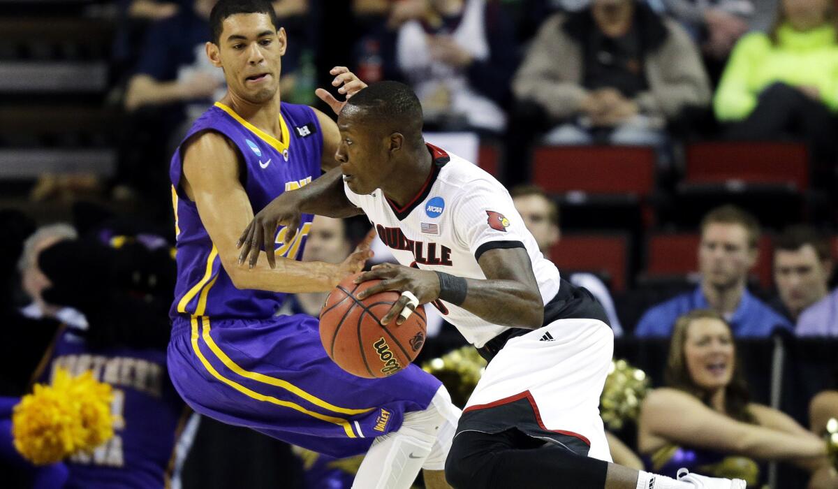 Louisville guard Terry Rozier drives past Northern Iowa guard Jeremy Morgan in the first half of the Cardinals' 66-53 victory over the Panthers on Sunday.