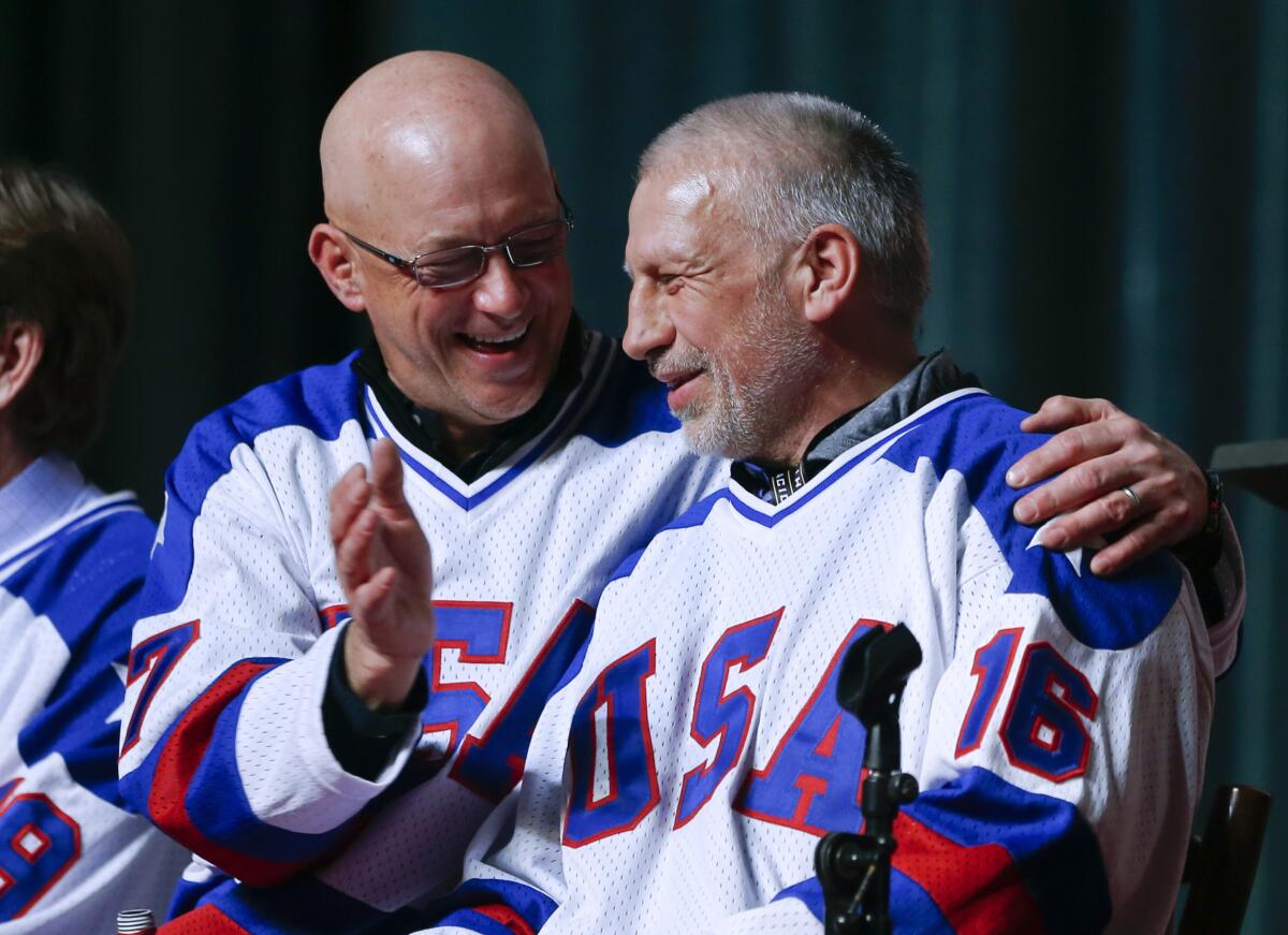 In this Feb. 21, 2015, file photo, Jack O'Callahan and Mark Pavelich of the 1980 U.S. ice hockey team.