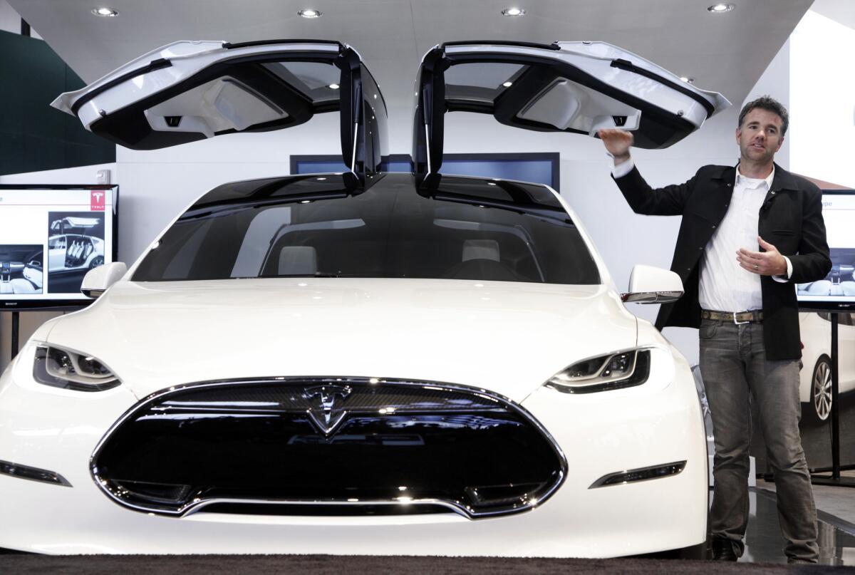 Franz von Holzhausen, Tesla Motors' chief designer, talks about the doors on the Tesla Model X at the 2013 North American International Auto Show in Detroit.