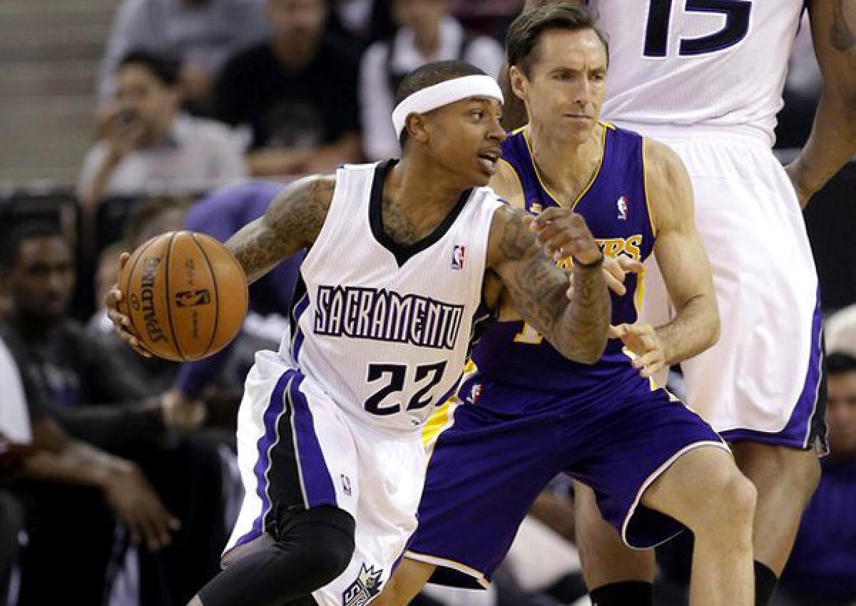 Lakers point guard Steve Nash hasn't played since March 30, when he didn't last long because of a strained hamstring. Above, he tries in that game to defend against Sacramento's Isaiah Thomas.
