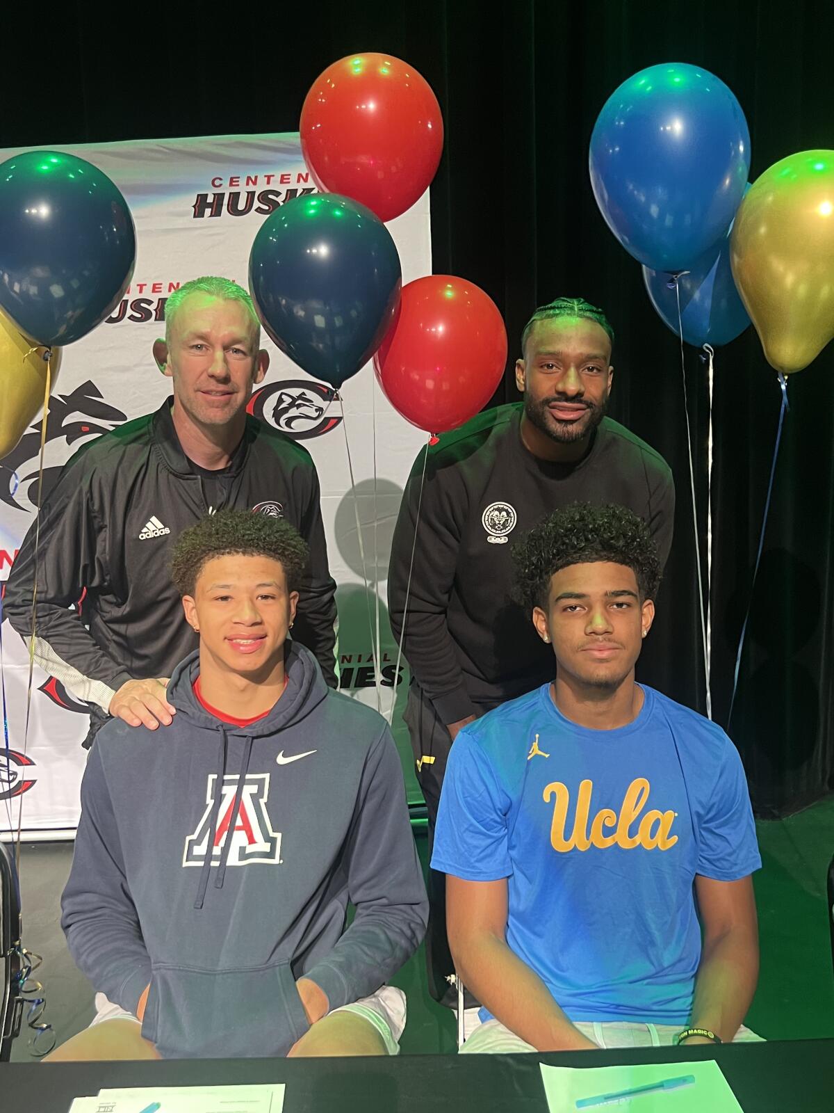 Corona Centennial coaches Josh Giles and Shannon Sharpe with Carter Bryant and Eric Freeny,