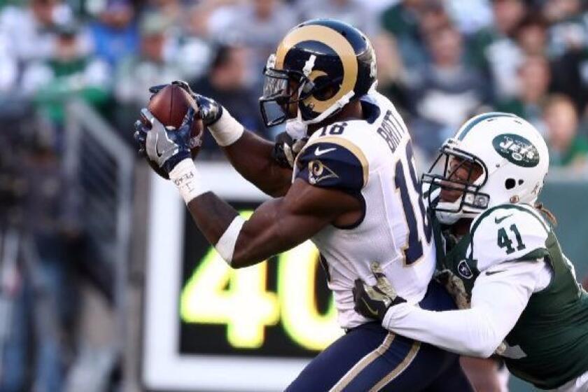 Rams receiver Kenny Britt makes a catch against Jets cornerback Buster Skrine during a game on Nov. 13.