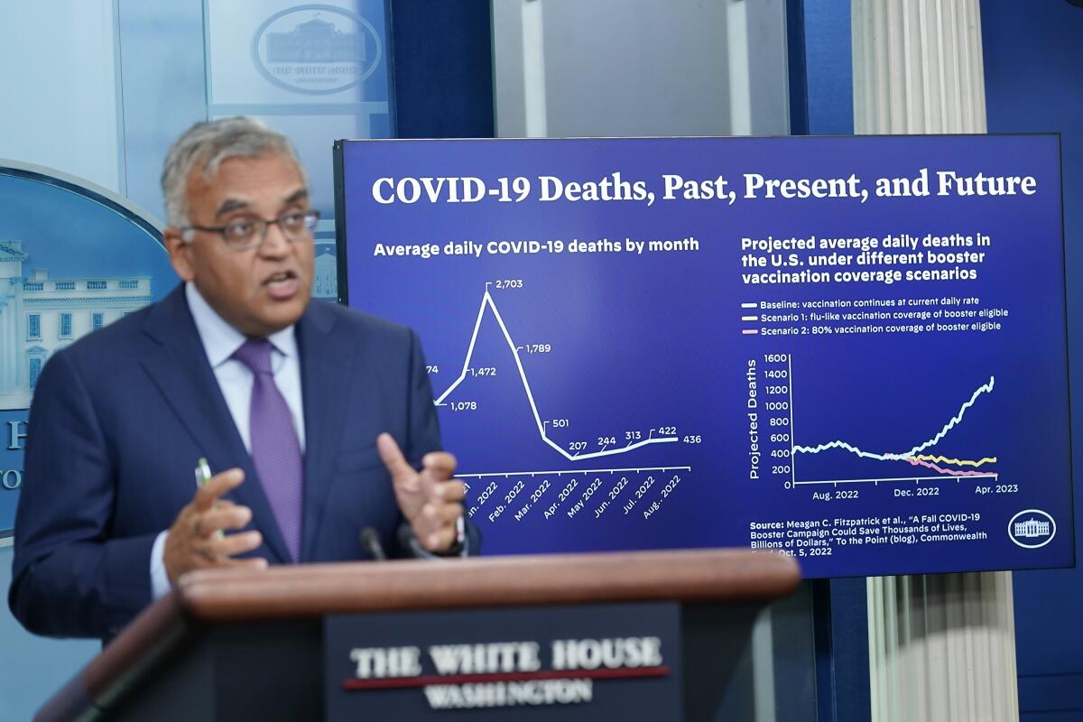 A man with a chart of COVID-19 deaths