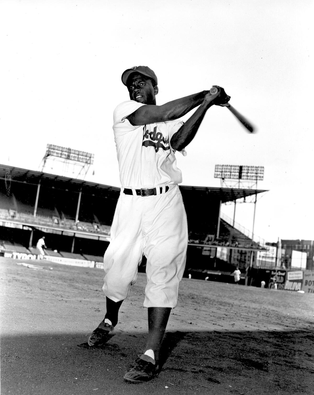  Jackie Robinson, infielder for the Brooklyn Dodgers, swings his bat at Ebbett's Field on May 9, 1951. 