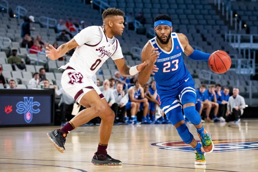 Boise State forward Naje Smith (23) attempts to drive to the basket past Texas A&M guard Dexter Dennis (0) during the first half of an NCAA college basketball game in Fort Worth, Texas, Saturday, Dec. 3, 2022. (AP Photo/Emil Lippe)