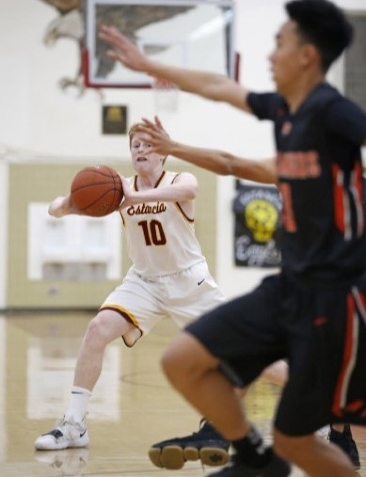 Estancia's Brandon Pearson, shown passing the ball against Los Amigos on Dec. 26, 2018, led the Eagles to a 55-51 win over Pacifica on Friday in the Los Amigos Winter Classic semifinals.