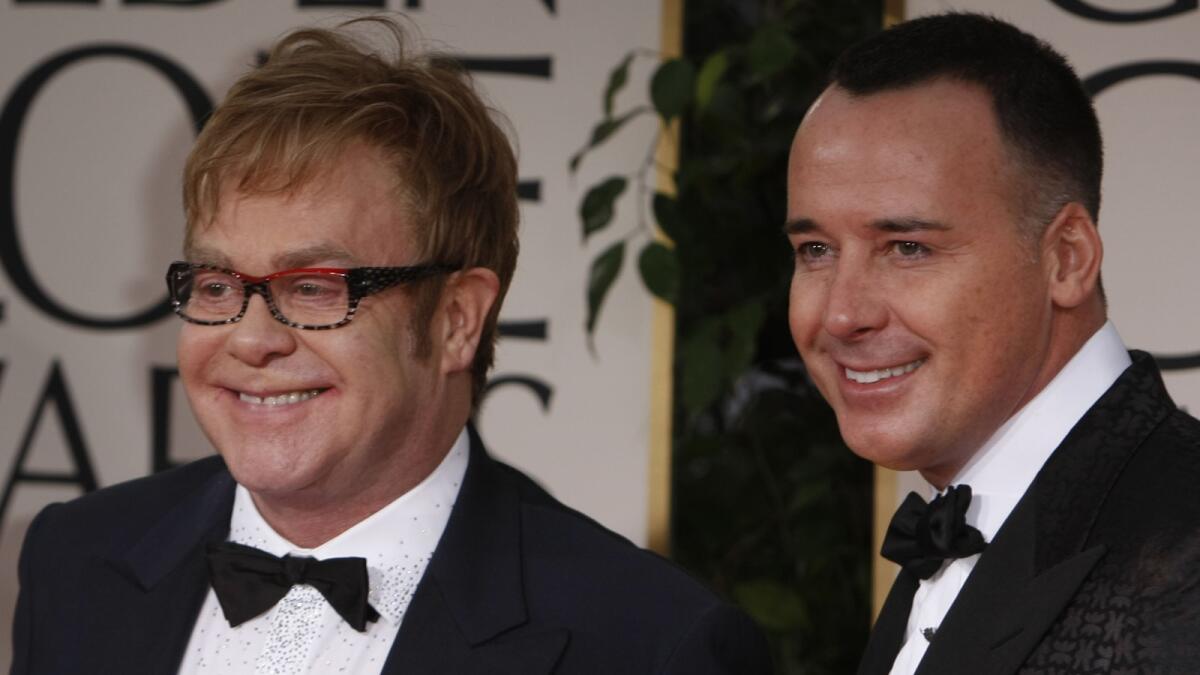 Elton John and David Furnish formed a civil partnership in 2005, one of the first gay couples to do so after England made same-sex partnerships legal.
