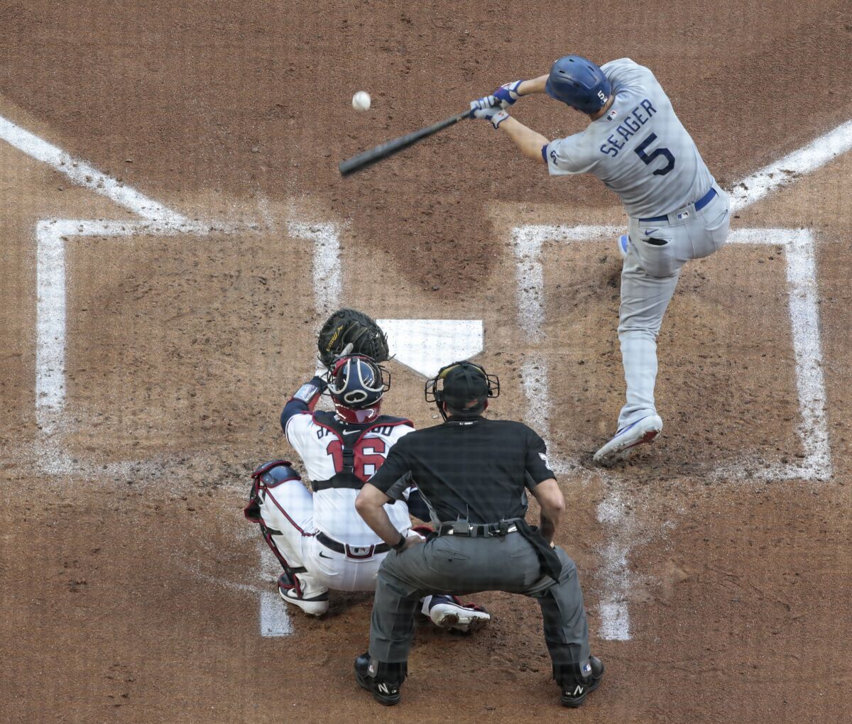 Dodgers shortstop Corey Seager hits a run-scoring single during the first inning in Game 3 of the NLCS.