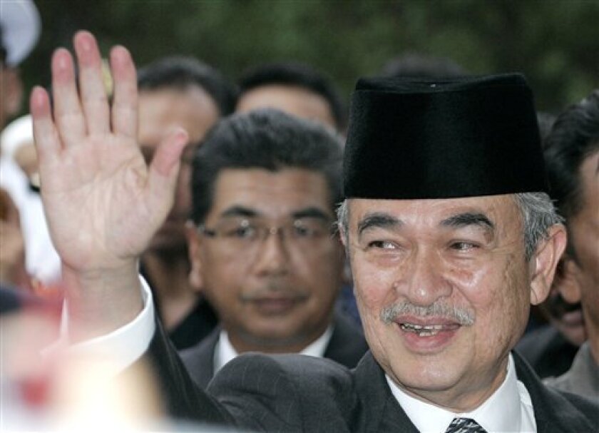 Malaysian outgoing Prime Minister Abdullah Ahmad Badawi, also defence minister, waves during a farewell ceremony organized by the Defence Ministry in Kuala Lumpur, Malaysia, Thursday, April 2, 2009. Abdullah resigned Thursday after five and half years of largely ineffectual rule in a prelude to handing power to his deputy, who faces the mammoth task of rebuilding the economy and the ruling party's shattered reputation. (AP Photo/Lai Seng Sin)