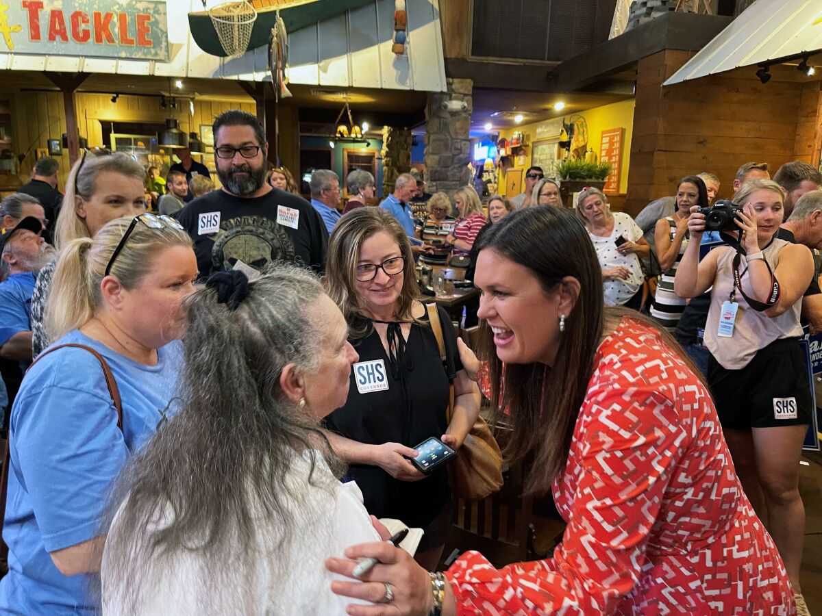 FILE - In this Sept. 10, 2021, file photo, former White House press secretary Sarah Sanders, right, greets supporters at an event for her campaign for governor at a Colton's Steak House in Cabot, Ark. Sanders has raised $2.1 million over the past three months in her bid to be Arkansas' next governor, her campaign announced Thursday, Oct. 14, 2021. (AP Photo/Andrew DeMillo)
