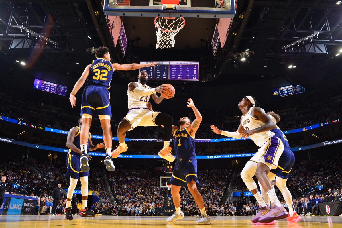 Lakers star LeBron James drives to the basket against the Golden State Warriors.