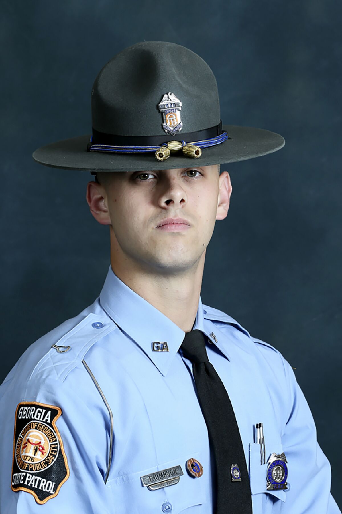 In this undated photo released by the Georgia Department of Public Safety, State trooper Jacob Gordon Thompson is seen in an official portrait. The Georgia Bureau of Investigation said in a statement Friday, Aug. 14, 2020 that Thompson was charged with felony murder and aggravated assault. The trooper has been fired and charged with murder a week after he fatally shot a 60-year-old man who attempted to flee a traffic stop. (Georgia Department of Public Safety via AP)
