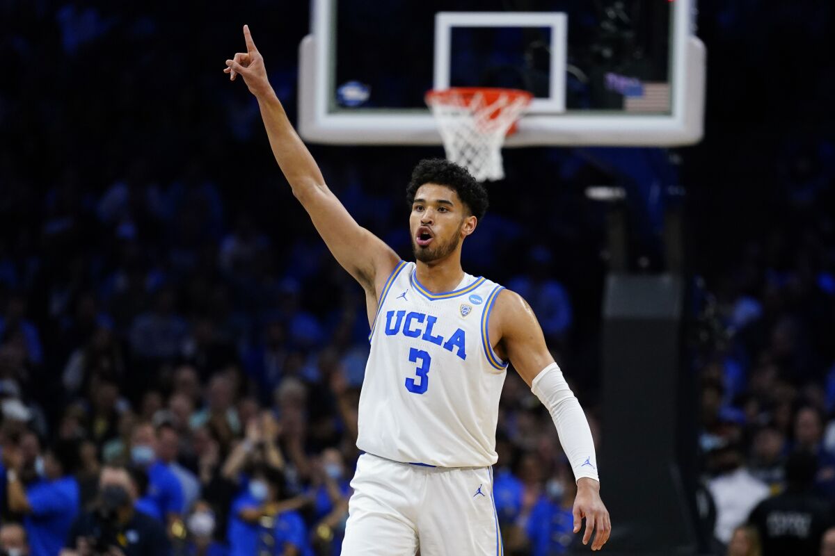 UCLA's Johnny Juzang reacts during the first half of a college basketball game against North Carolina in the Sweet 16 round of the NCAA tournament, Friday, March 25, 2022, in Philadelphia. (AP Photo/Matt Rourke)