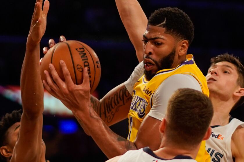 LOS ANGELES, CALIF. - OCTOBER 29: Los Angeles Lakers forward Anthony Davis (3) recovers the ball against the Memphis Grizzlies during a NBA game between the Memphis Grizzlies and the Los Angeles Lakers at Staples Center on Tuesday, Oct. 29, 2019 in Los Angeles, Calif. (Kent Nishimura / Los Angeles Times)
