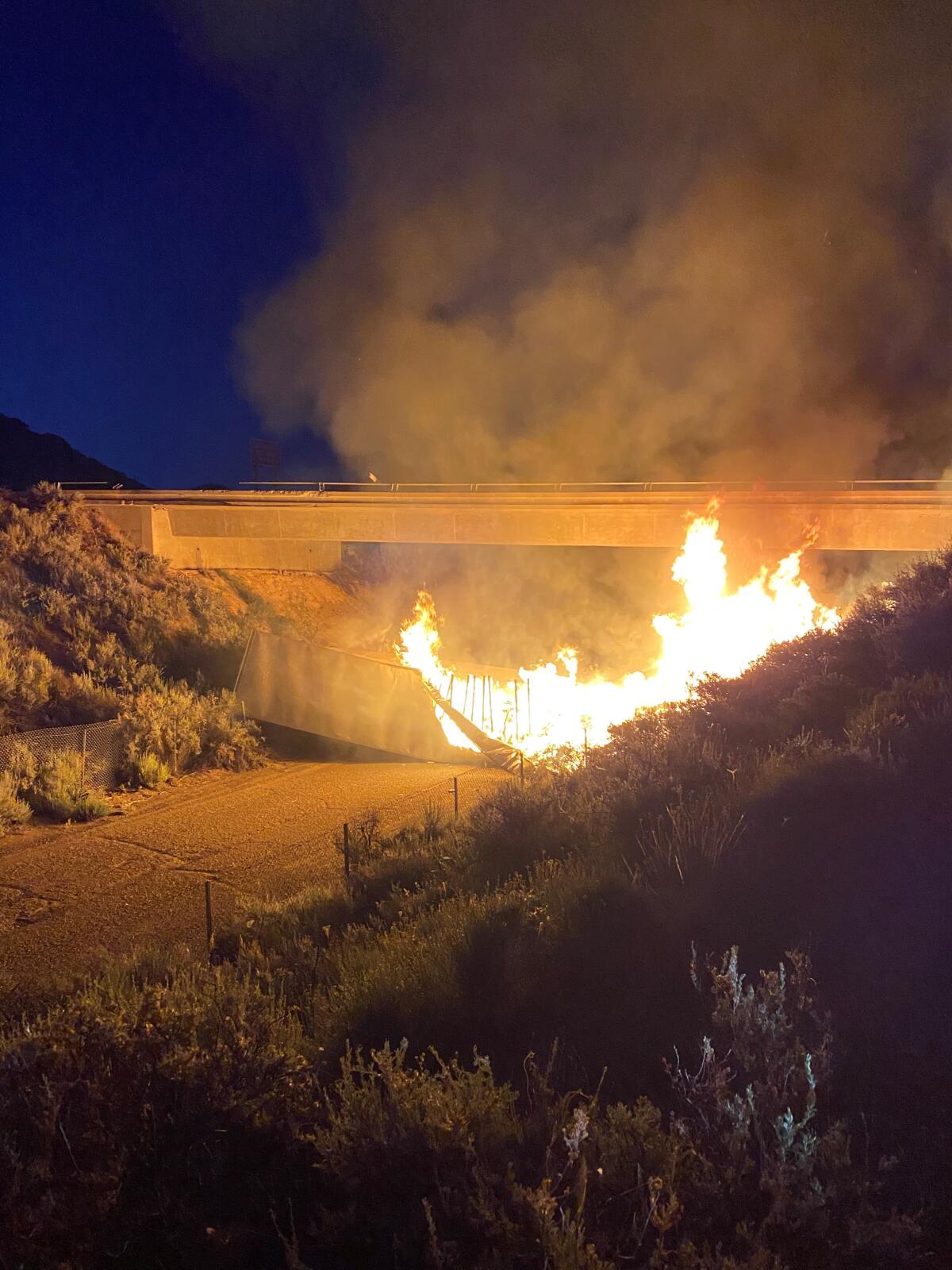 A semi trailer burns Wednesday night after it crashed off an I-8 bridge in the East County mountains.
