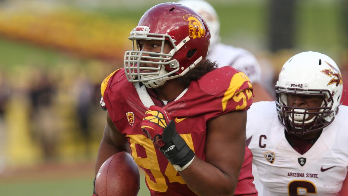 USC defensive tackle Leonard Williams returns an interception against Arizona State in 2012. Williams has kept a humble attitude on the way to becoming one of the best defensive players in the nation.