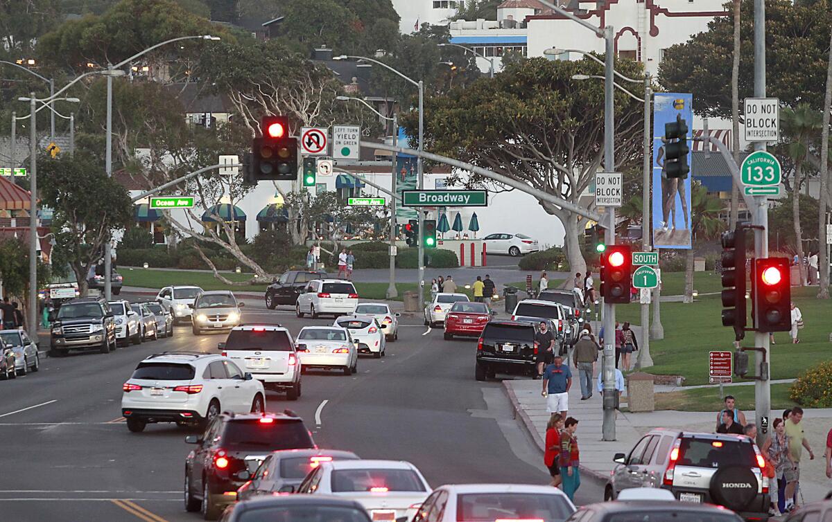 Cars pass through traffic near Broadway Street in Laguna Beach.