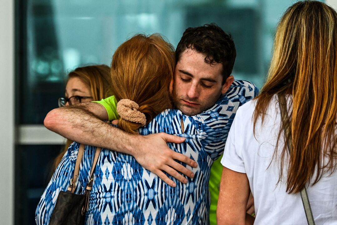 A woman and man hug each other.