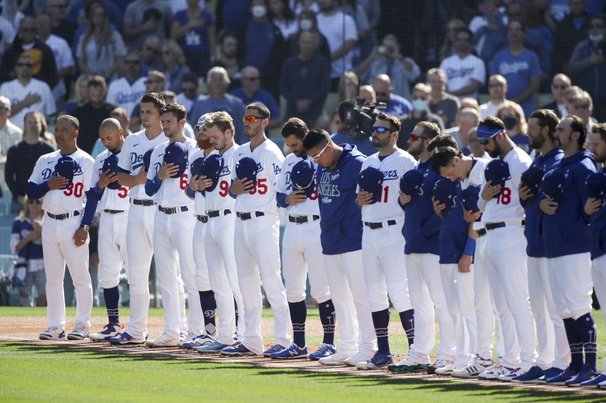 Dodgers stand for the national anthem before Game 3.