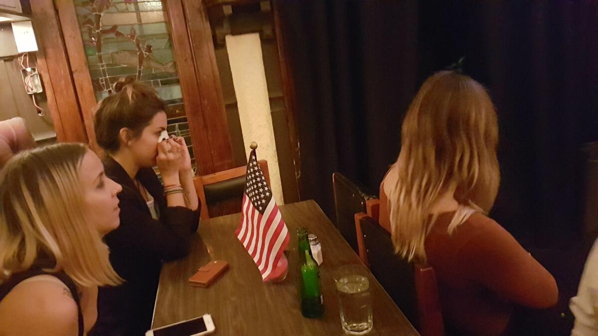 Alexandra Baker, 28, cries as she watches Donald Trump's first speech as president-elect from Legion Americana bar in Mexico City