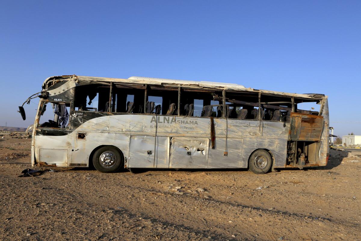A bus sits damaged after a fatal crash on the outskirts of Maan, Jordan.