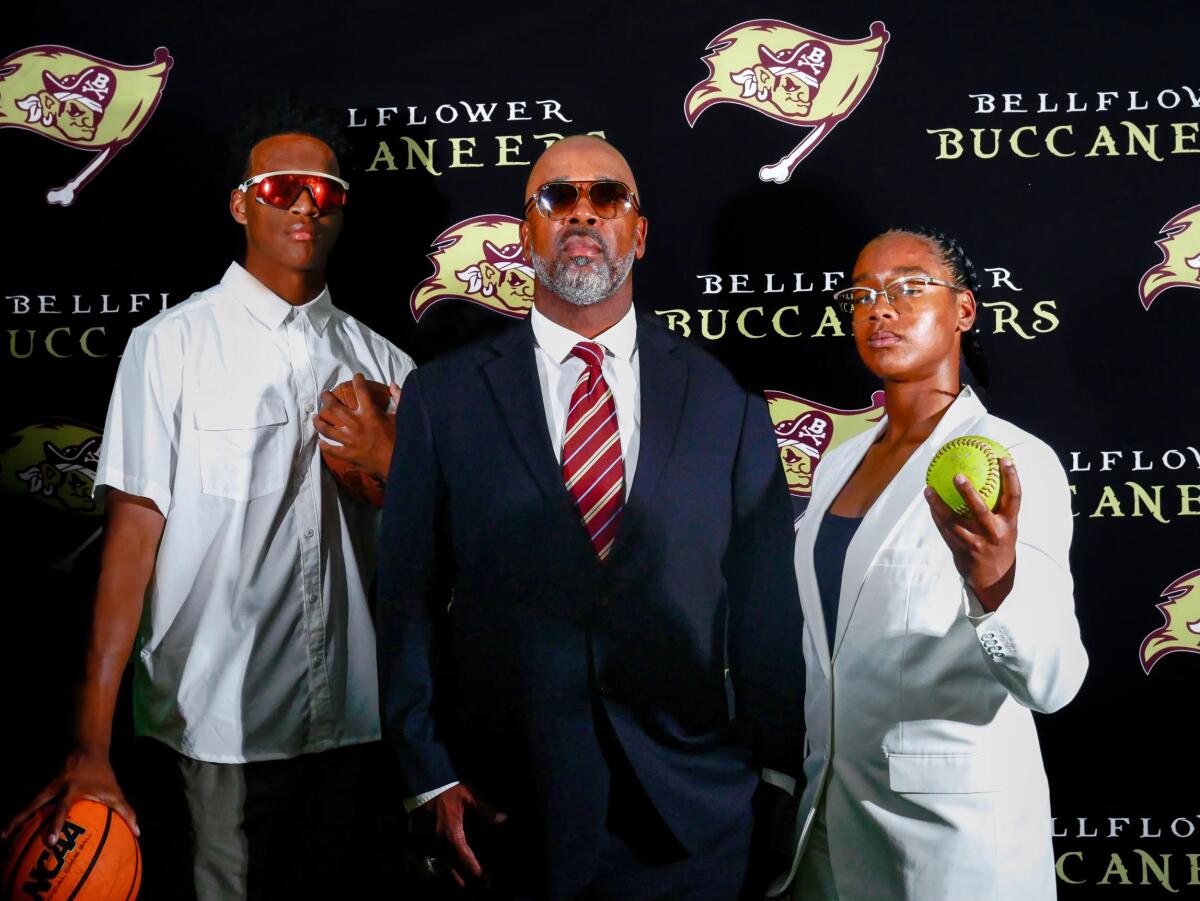 New Bellflower football coach Keith Miller, center, poses for a photo with son Austin, left, and daughter Jazelle.
