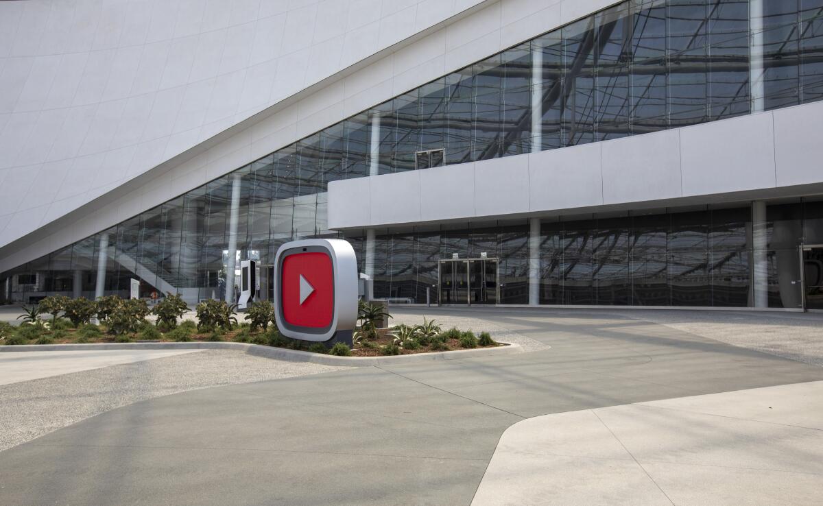 The YouTube logo of a giant play button is outside of the new YouTube Theater, a 6,000-seat performance venue.