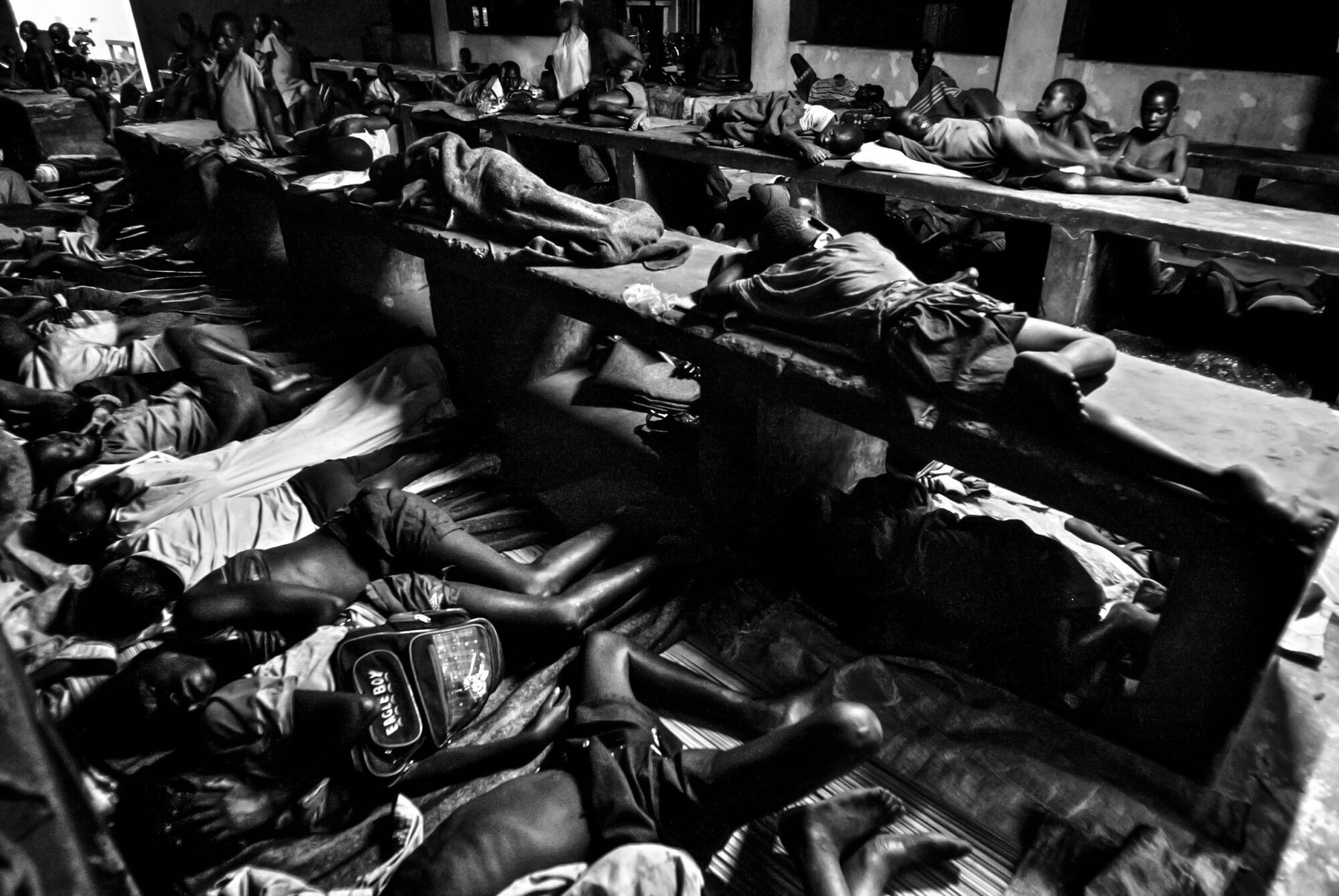 Children sleep closely packed together in a black and white image