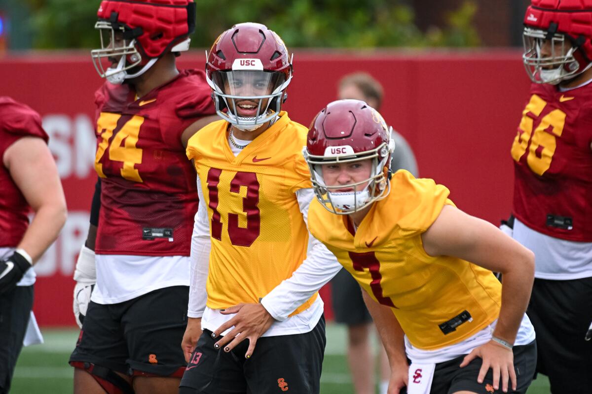 USC quarterbacks Caleb Williams (13) and Miller Moss warm up during practice in August 2022.