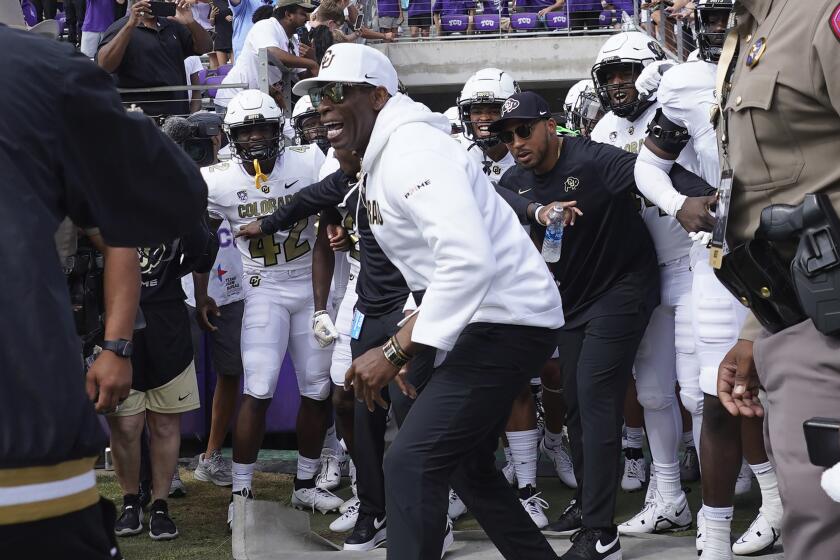 Colorado head coach Deion Sanders runs onto the field with his team for a an NCAA college football game against TCU Saturday, Sept. 2, 2023, in Fort Worth, Texas. (AP Photo/LM Otero)