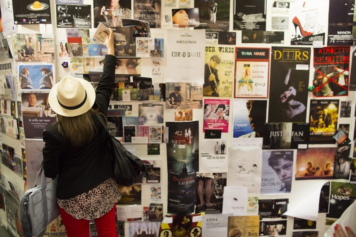 Movie posters are displayed on a wall at the film market at the 66th Cannes Film Festival.