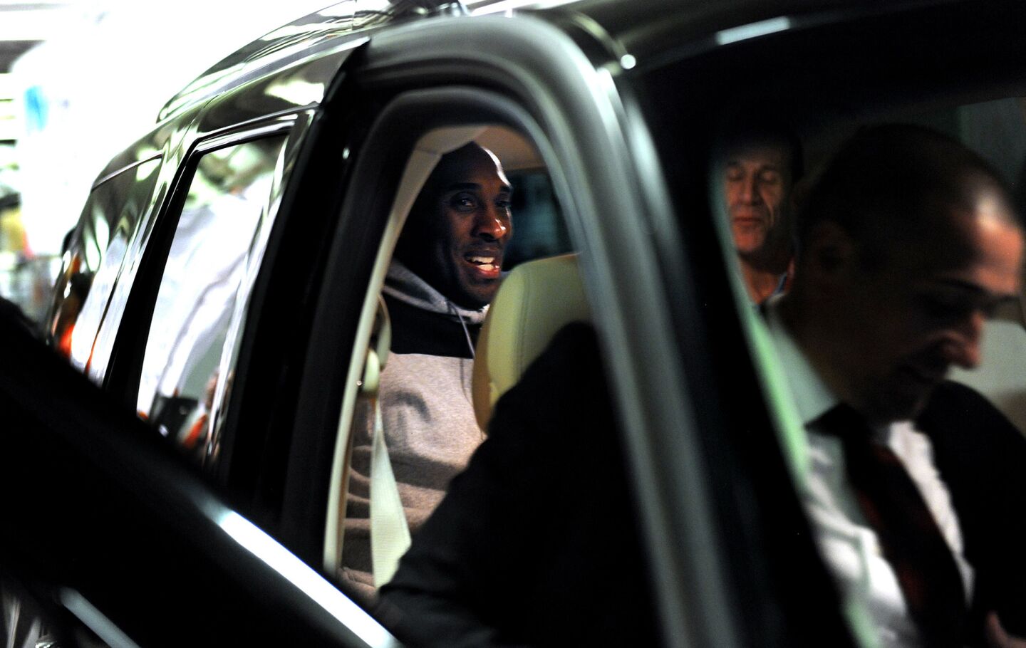 Kobe Bryant gets into the back of a private vehicle with his security team while leaving the arena in Phoenixon March 23.