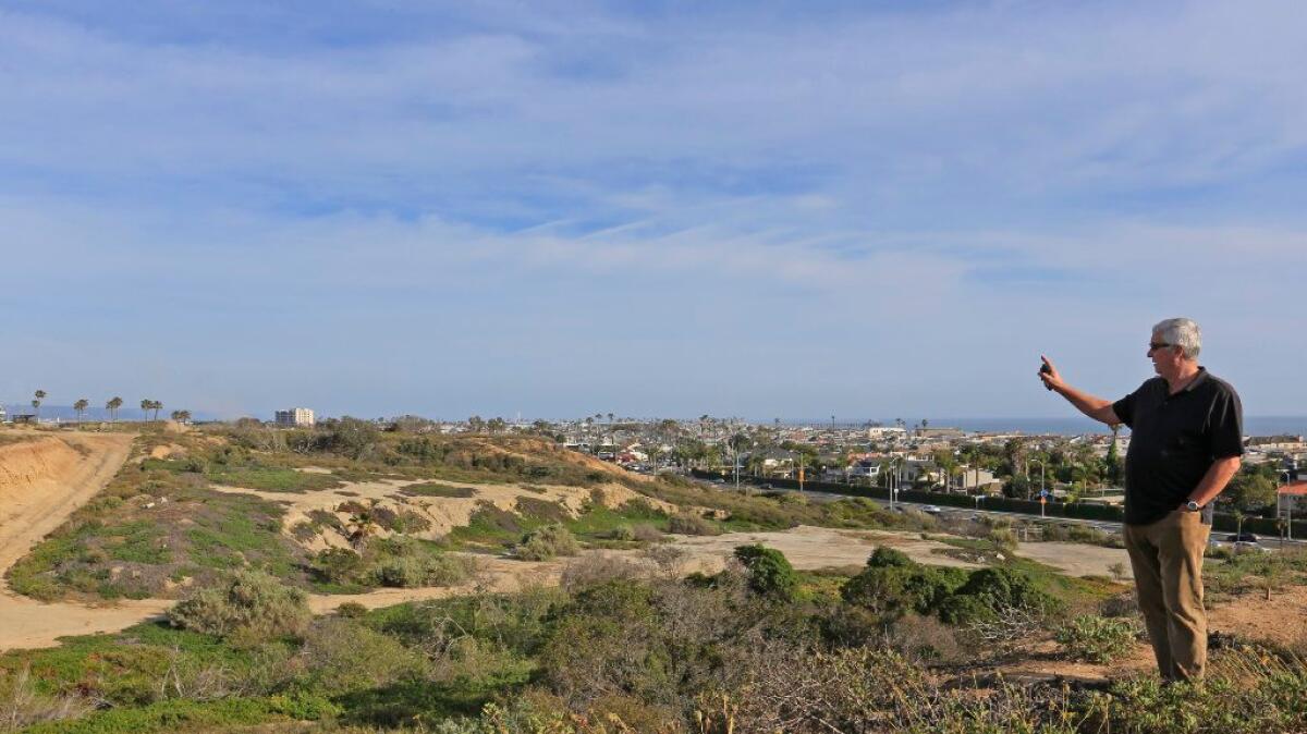 George Basye, president of Newport Banning Ranch, looks over part of the property where the entrance is planned.