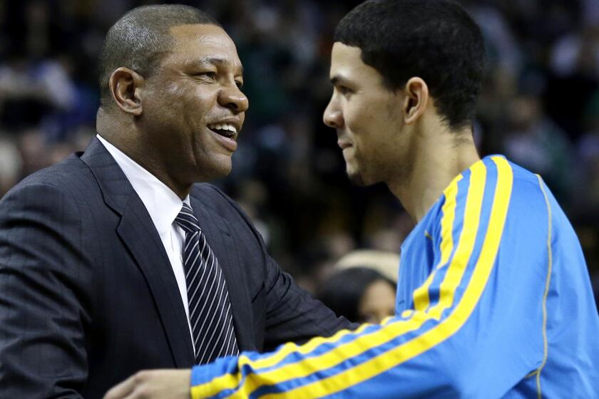 Doc Rivers, then the Boston Celtics' coach, greets his son, Austin, when he was a rookie with New Orleans.
