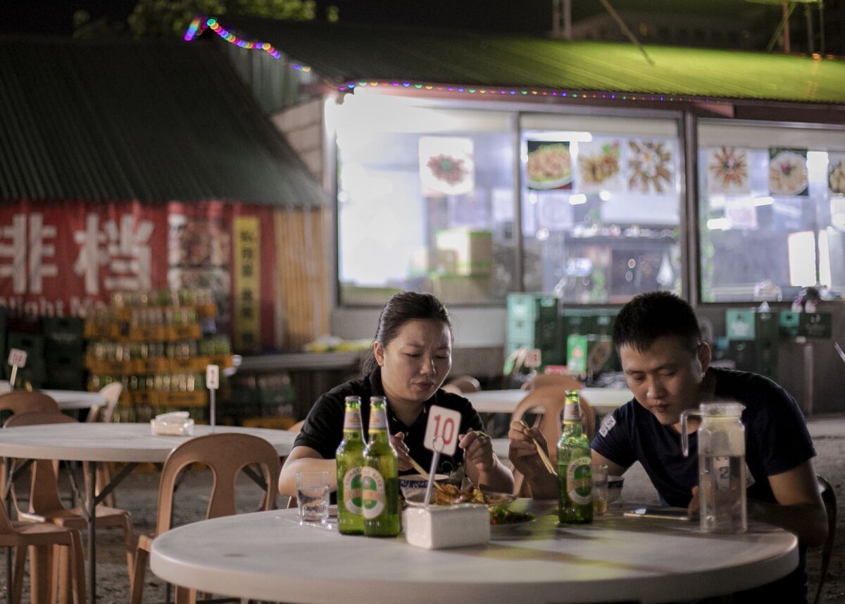 Chinese customers dine in a Chinese night market in Pasay City, Philippines. The influx of Chinese gambling employees has had a ripple effect on the local economy, particularly the rise of new Chinese restaurants.