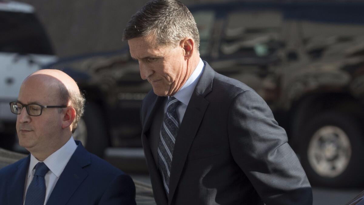 Michael Flynn, right, arrives at the E. Barrett Prettyman Federal Courthouse in Washington, D.C., on Dec. 1.