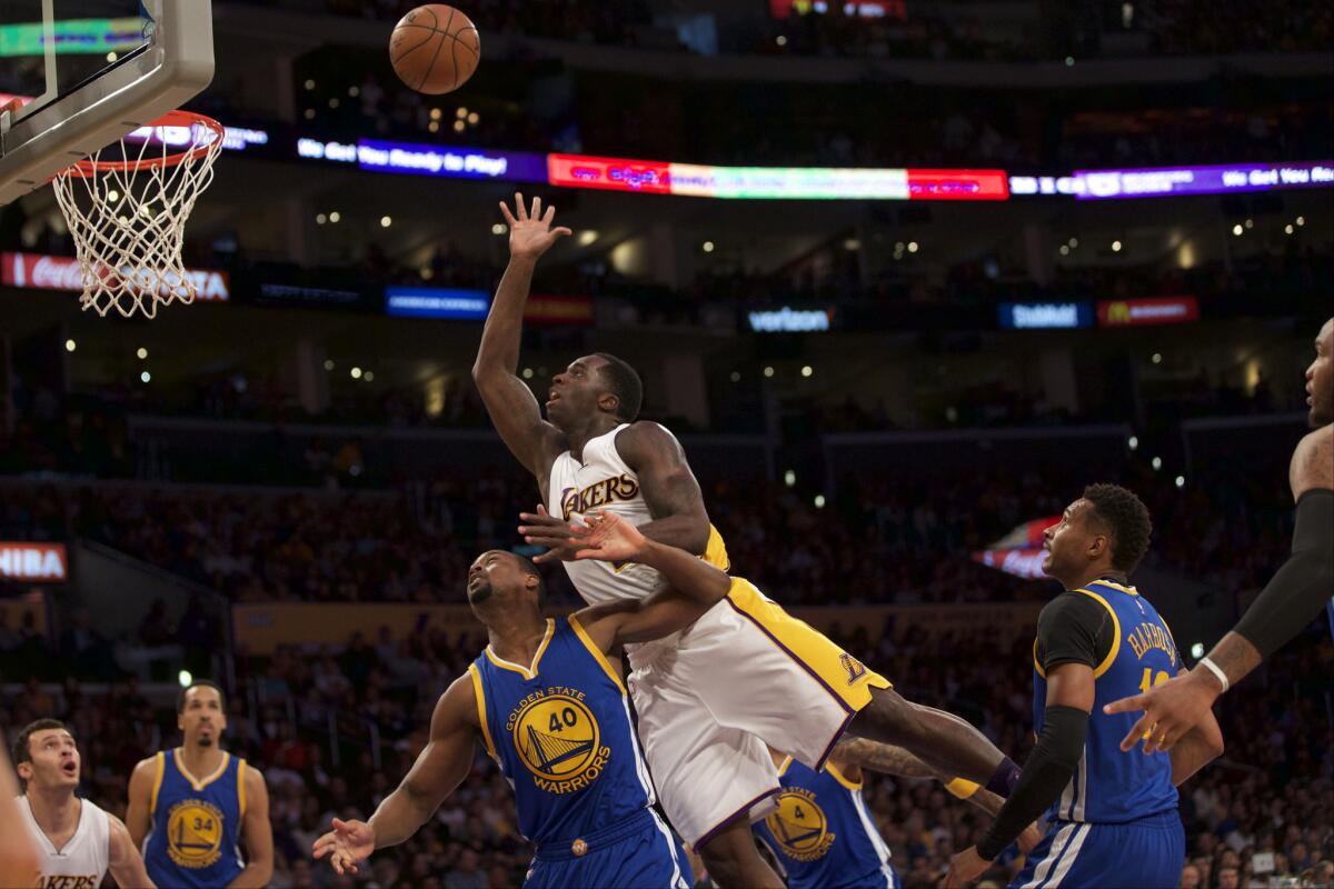 Lakers forward Brandon Bass puts up a shot against the Warriors during a game on March 6 at Staples Center. Randle finished with 12 points and 14 rebounds.