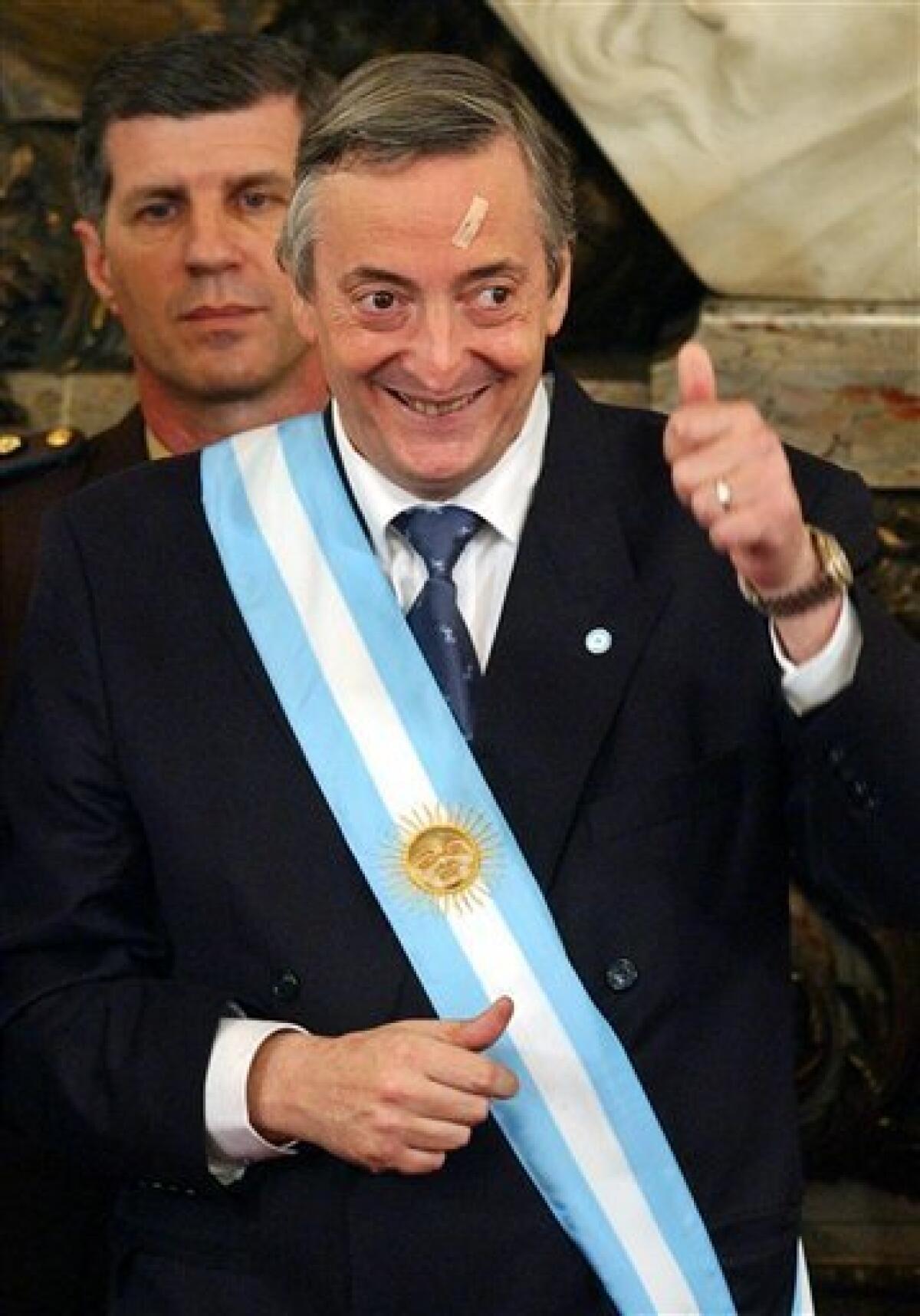 FILE - In this May 25, 2003 file photo, Argentina's President Nestor Kirchner gives a thumbs up after being sworn-in as president at the government palace in Buenos Aires, Argentina. According to state television in Argentina, Nestor Kirchner died on Wednesday Oct. 27, 2010 after suffering heart attacks at age 60. Kirchner served as president from 2003-2007. (AP Photo/Ezequiel Pontoriero, File)