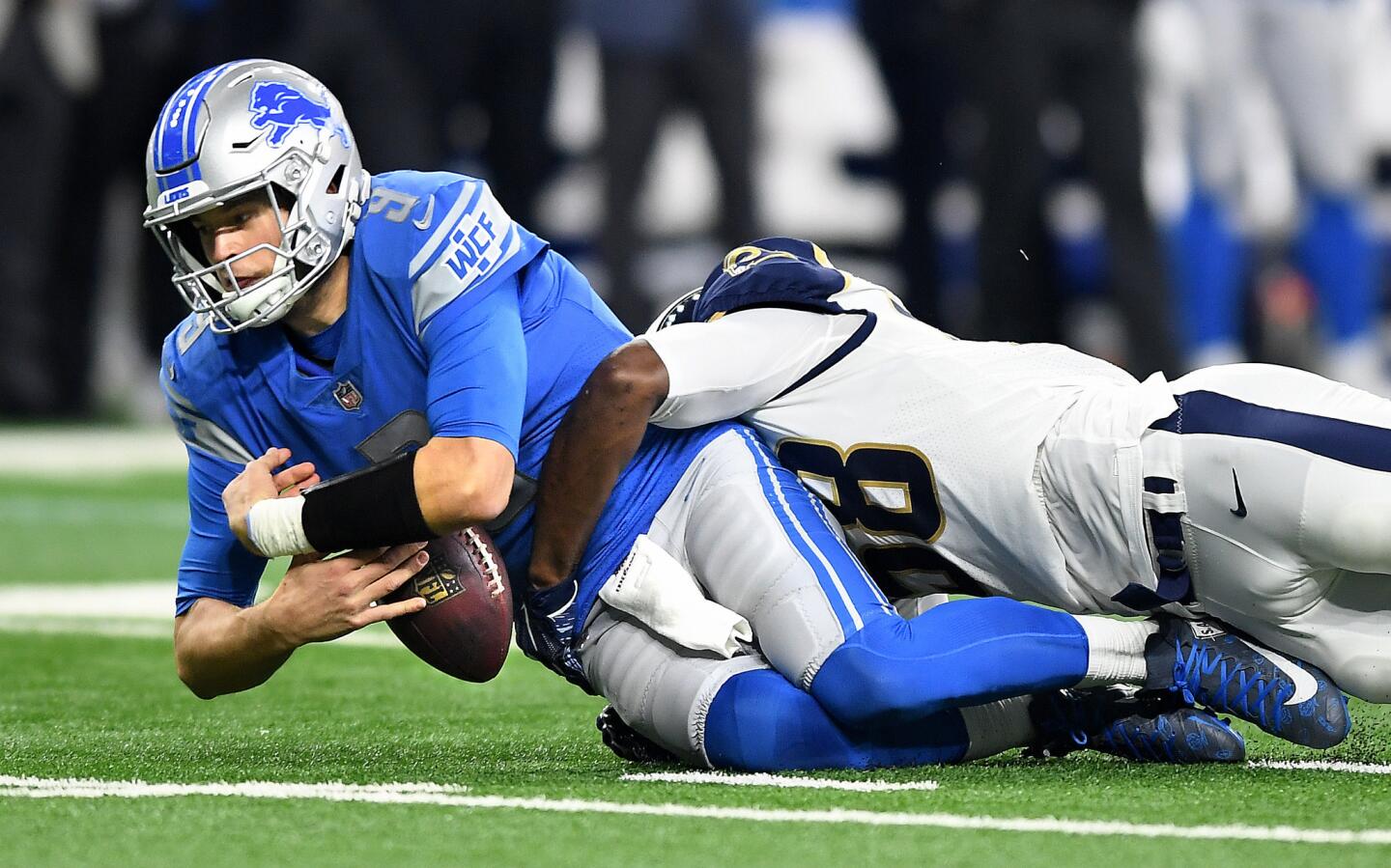 Detroit Lions quarterback Matthew Stafford fumbles the ball while being sacked by Rams linebacker Cory Littleton in the second quarter at Ford Field in Detroit on Sunday. The officails ruled he was down when tackeld.