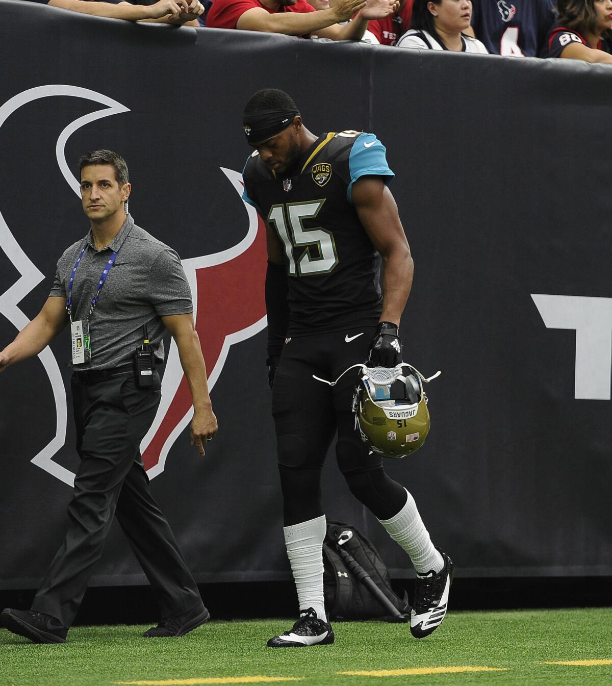 Jaguars receiver Allen Robinson (15) walks off the field after suffering an injury during the first half of a game in Houston.